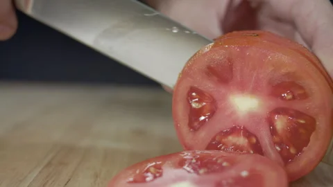 Macro wide close up of knife slicing and chopping a red tomato salad, food, Stock Footage 273512574