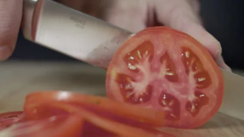 Macro wide close up of knife slicing and chopping a red tomato salad, food, Stock Footage 273512577