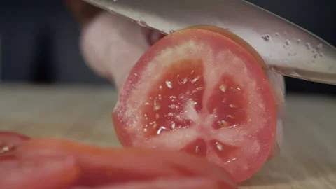 Macro wide close up of knife slicing and chopping a red tomato salad, food, Stock Footage 273512631