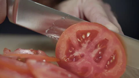 Macro wide close up of knife slicing and chopping a red tomato salad, food, Stock Footage 273512960