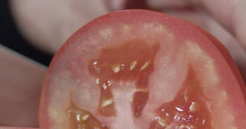 Macro wide close up of knife slicing and chopping a red tomato salad, food, Stock Footage 273513308