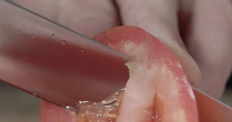 Macro wide close up of knife slicing and chopping a red tomato salad, food, Video stock 273513328