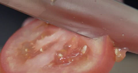Macro wide close up of knife slicing and chopping a red tomato salad, food, Stock Footage 273513340