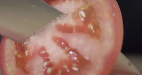 Macro wide close up of knife slicing and chopping a red tomato salad, food, Stock Footage 273513348