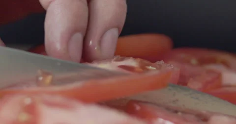 Macro wide close up of knife slicing and chopping a red tomato salad, food, Stock Footage 273513357