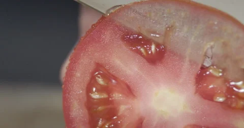 Macro wide close up of knife slicing and chopping a red tomato salad, food, Stock Footage 273513368