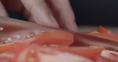Macro wide close up of knife slicing and chopping a red tomato salad, food, Stock Footage 273513370