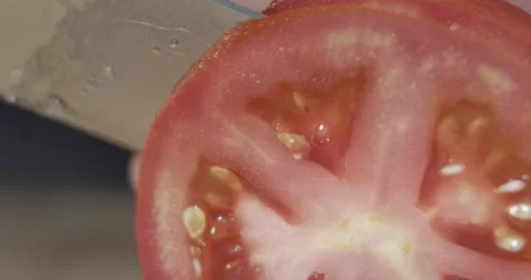Macro wide close up of knife slicing and chopping a red tomato salad, food, Stock Footage 273513379