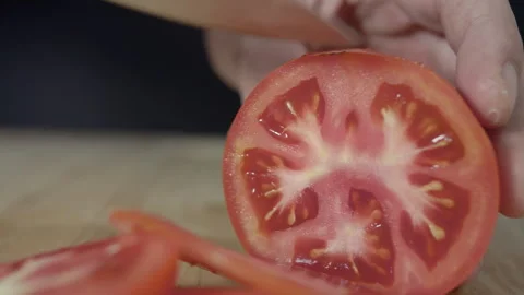 Macro wide close up of knife slicing and chopping a red tomato salad, food, Stock Footage 273513382