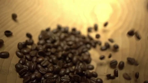 Macro wide shot of coffee beans being poured into a wooden bowl in super slow Stock Footage 87857493