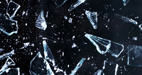 Macro of window crystal glass panel shattering in explosion with flying pieces Stock Footage 268422528