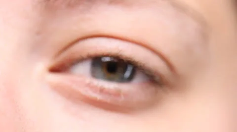 Macro of woman's eye opening, rack-focus in. HD 1080p 24fps. Stock Footage 22733664