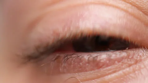 Macro of woman's eye opening, water-bubble on eye. HD 1080p 24fps. Stock Footage 22734204