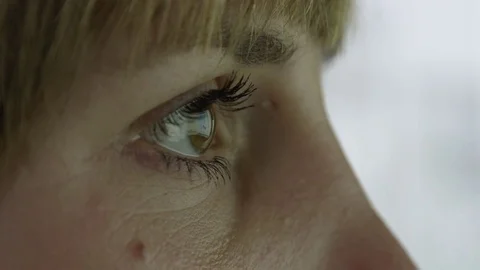 MACRO: Woman's eyes reflecting screen while scanning through charts and graphs Stock Footage 73502055