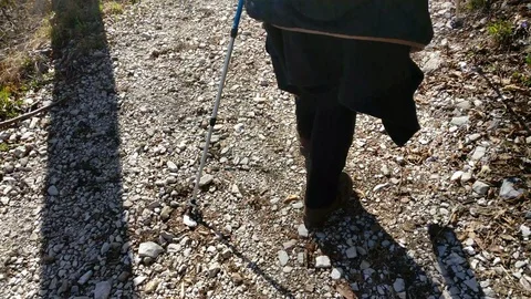 Macro of woman's legs that is doing the scandal walking with sticks in mountain Stock Footage 90428833