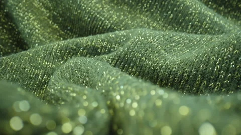 Macro wool fabric. Dolly knitted textile green color texture with golden threads Stock Footage 234149717