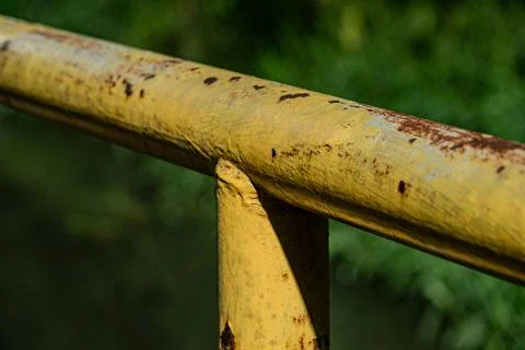 Macro of yellow rusty iron railing texture at night Photos
