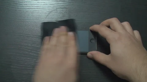 Macro Of A Young Man Cleaning His Smartphone Above-Shot Vídeos de archivo 34045498