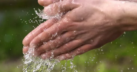 Macro of young man washing hands with clear pure water flowing stream Stock Footage 268438090
