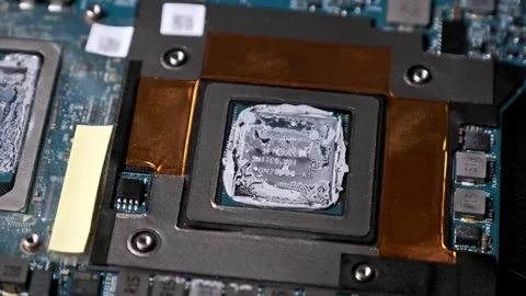 Macro Zoom-In on a CPU with Thermal Compound on a Circuit Board Stock Footage 314129643