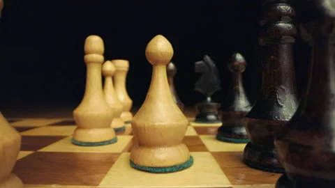 Macro zoom out between two rows of chess pieces on wooden chessboard Stock Footage 149336713