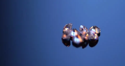 Macro Zoom of Tiny Synthetic Moissanite Diamonds 0.003 Carat each Sparkling with Видео 330956437