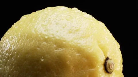 Macrography of a lemon against a bold black background. Close up. Comestible. Stock Footage 291129022