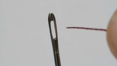 Macroshooting, threading of a thread in a needle ear Stock Footage 71138778
