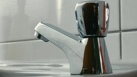 Macroshot of a silver fawcet from below Stock Footage 274320865