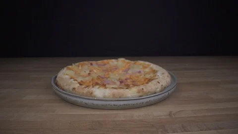 MacroSliding out of pizza on table dolly out Video stock 124016821