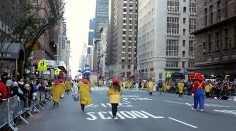 Macy's parade going between tall buildings Stock Footage 10562796