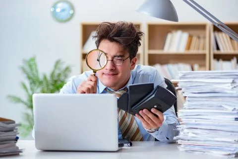 Mad auditor looking for errors in the report 스톡 사진