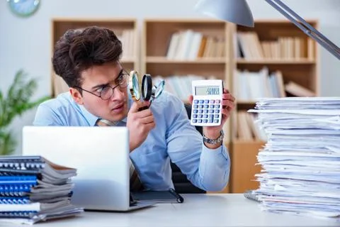 Mad auditor looking for errors in the report 스톡 사진