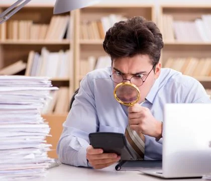 Mad auditor looking for errors in the report 스톡 사진