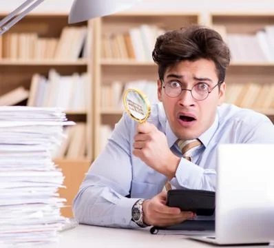 Mad auditor looking for errors in the report Stock Photos