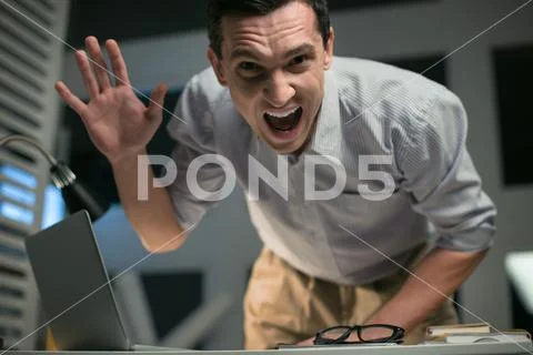 Mad male employee showing aggression Stock Photos