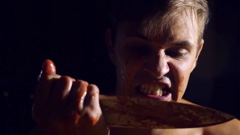 A mad man, a gripping knife, covered in blood, the hands of a ruthless maniac Stock Footage 79733907