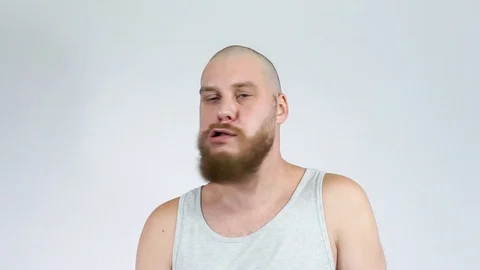 A mad man looking at the camera a crazy look and shakes his head. Stock Footage 122512565