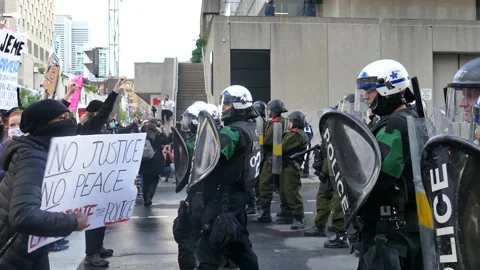 Mad protester screaming and insulting anti-riot police Stock Footage