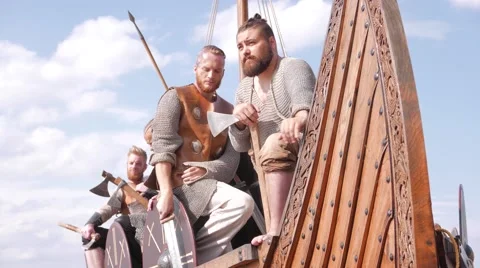 Mad vikings on the Drakkar on the river shore Stock Footage