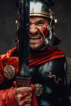 Mad warrior from rome staring at camera holding sword 스톡 사진