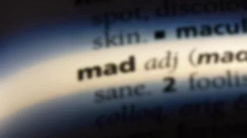 Mad word in a dictionary. Stock Footage 99563153