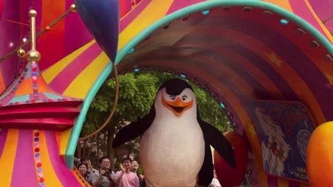 Madagascar characters on decorative float during amusement theme park parade. Stock Footage 338987983
