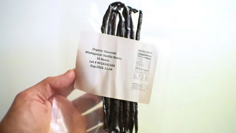 Madagascar vanilla beans bean in plastic bag, traditional spice macro closeup Stock Footage 321982753