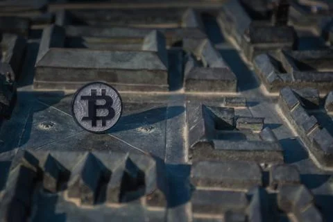 Made from black plastic custom bit coin on rustic old background Stock Photos