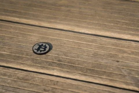 Made from black plastic custom bit coin on rustic old background 库存照片