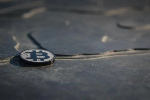 Made from black plastic custom bit coin on rustic old background 스톡 사진
