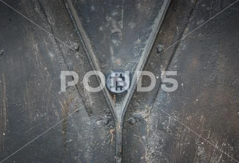 Made from black plastic custom bit coin on rustic old background Stock Photos