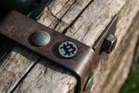 Made from black plastic custom bit coin on rustic old background Fotos de archivo