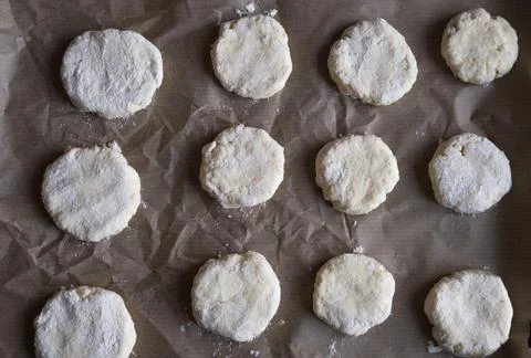 Made cookies before baking on bakery paper, from above. Stock Photos